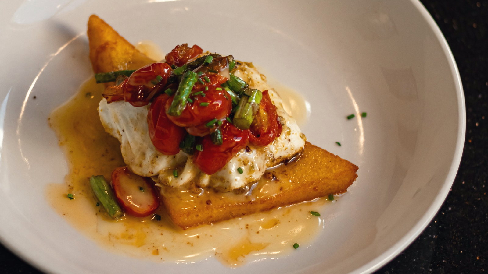Blistered tomato and burrata over polenta. The best color separation of any plate here.