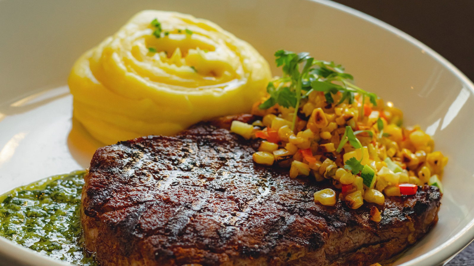 Grilled steak with whipped potato and corn salsa. The sharpest plate in the set and the natural lead food image.