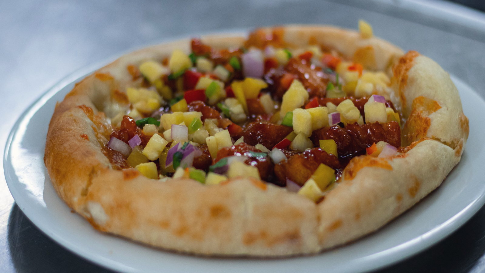 Wood-fired flatbread with fruit salsa, straight out of the oven the whole concept is built on.